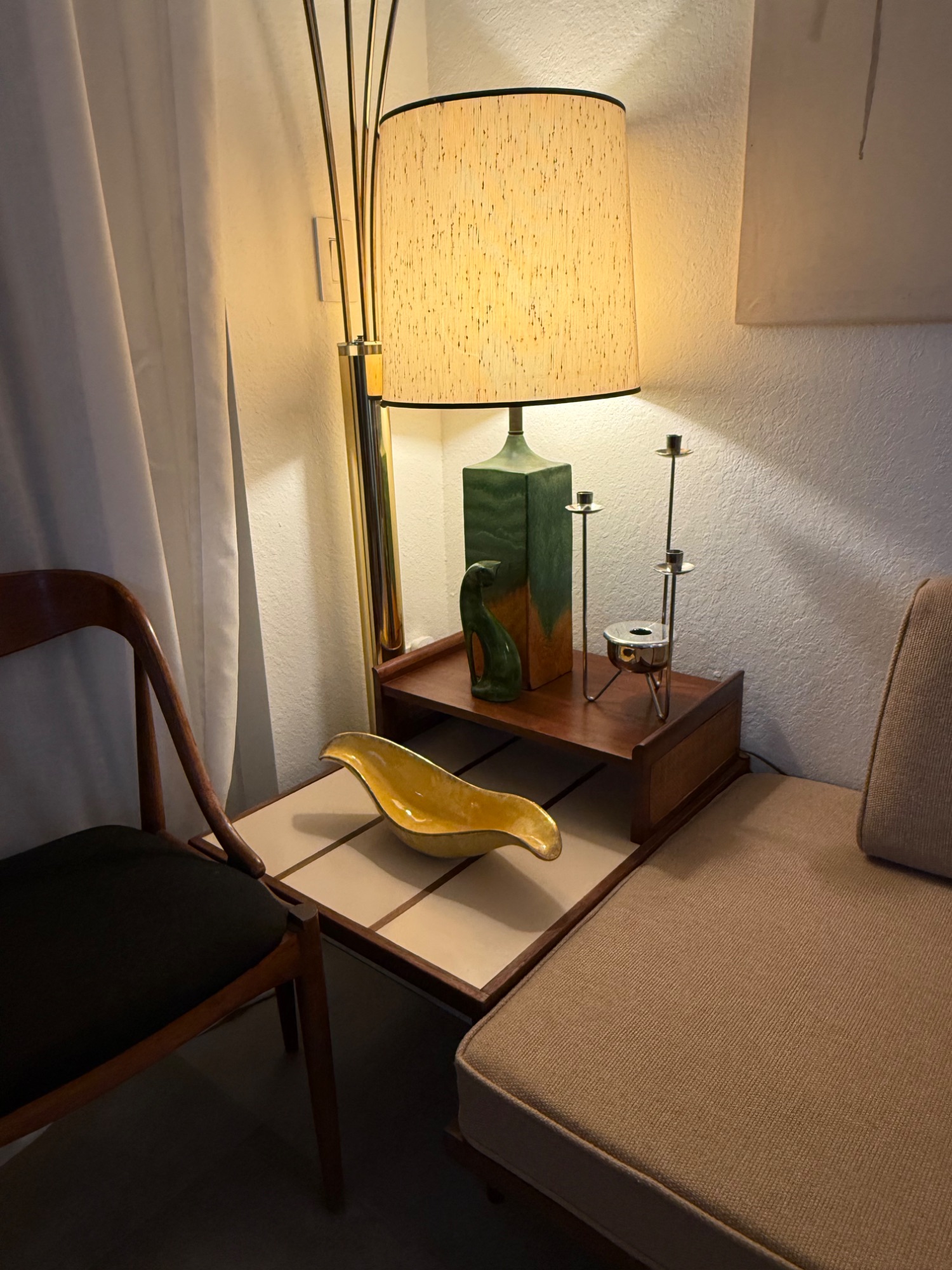 Reading nook with orange throw and arc lamp