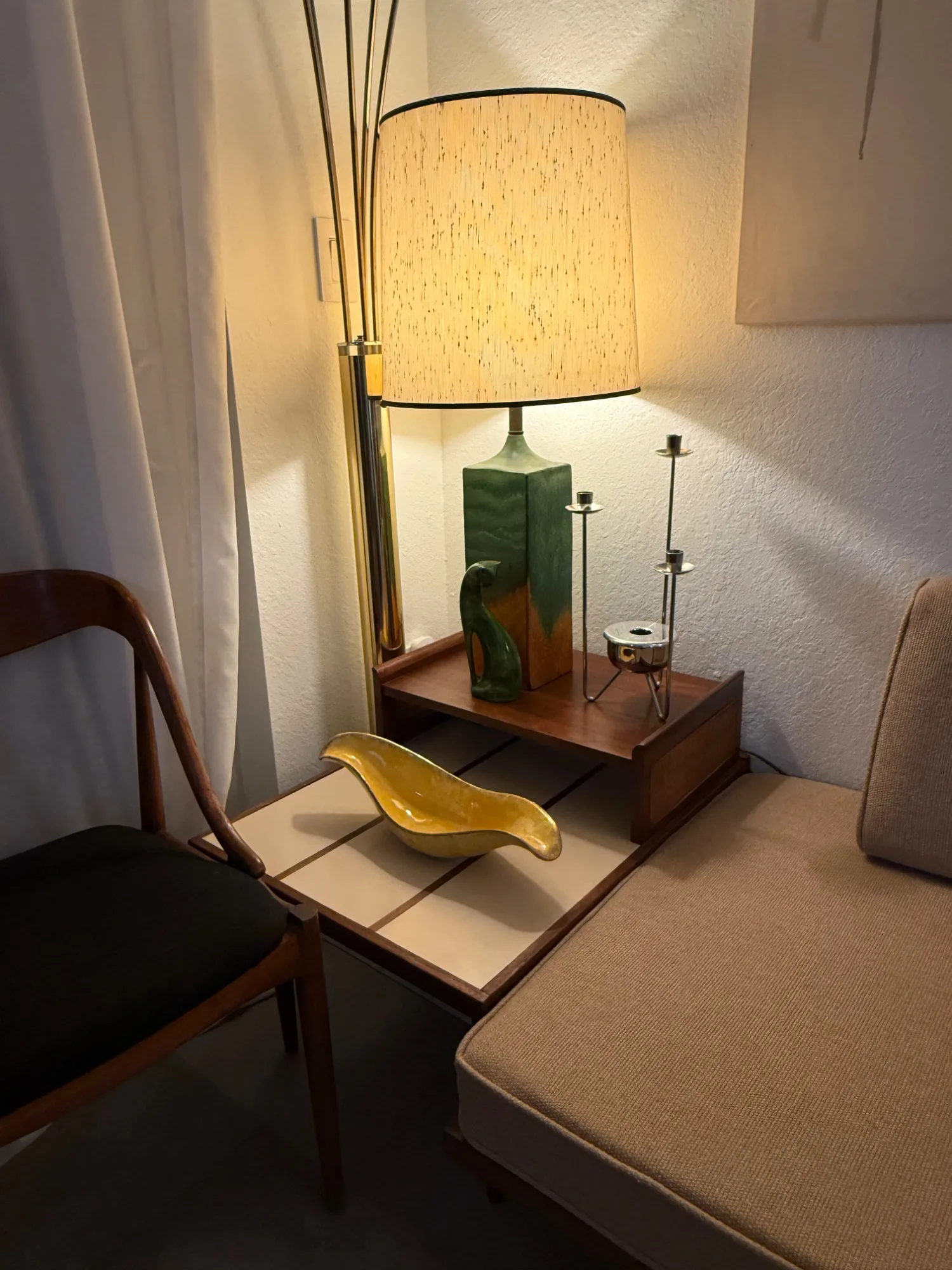 Reading nook with orange throw and arc lamp